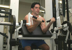 Model performing the contracting phase of the machine curl exercise