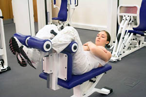 Girl performing the ending movement on an upper crunch ab machine