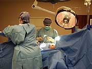 Surgeon performing breast implant surgery