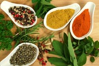 Herbs and spices on a wooden table.